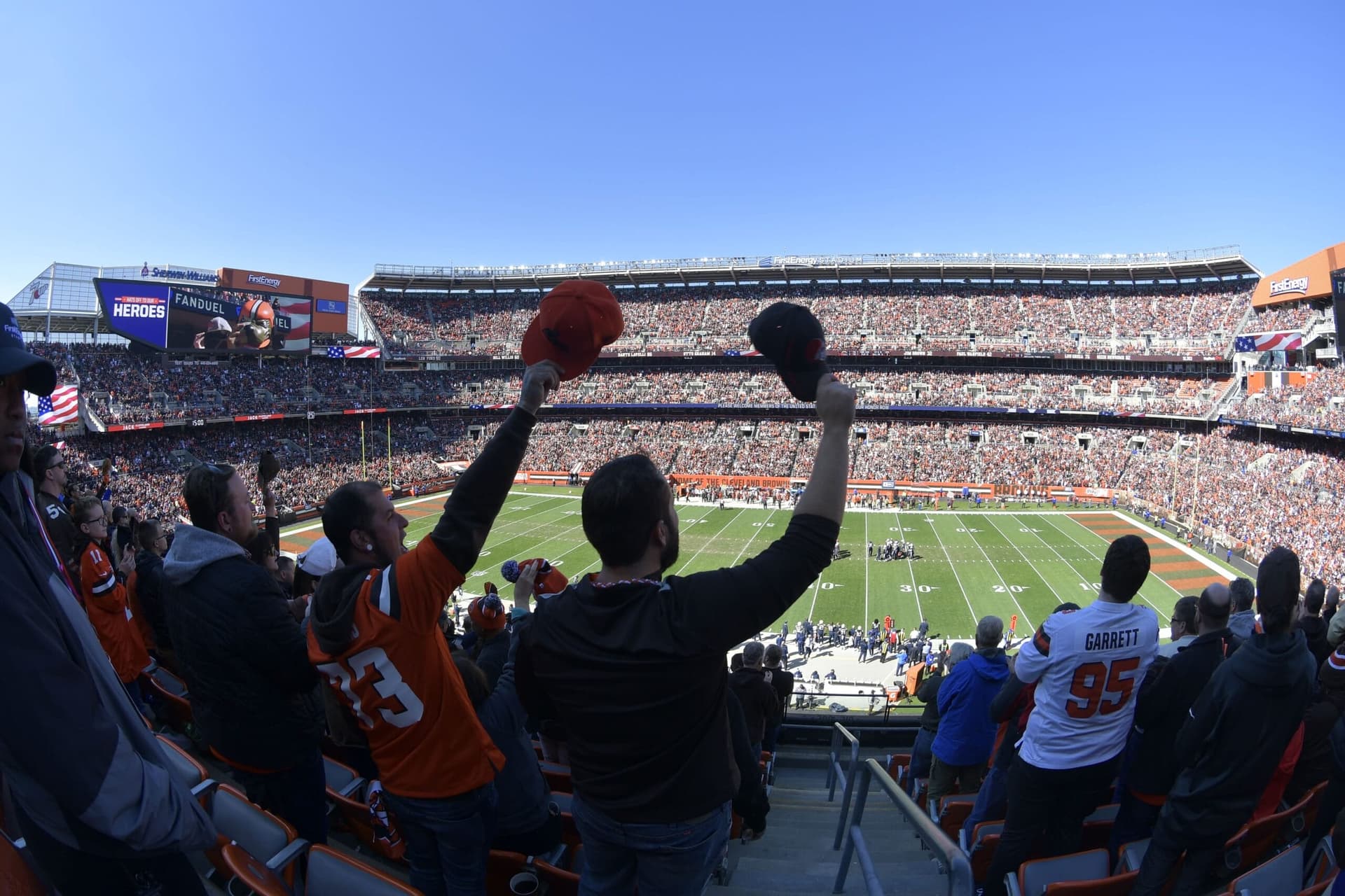 Fans in a packed football stadium during a game