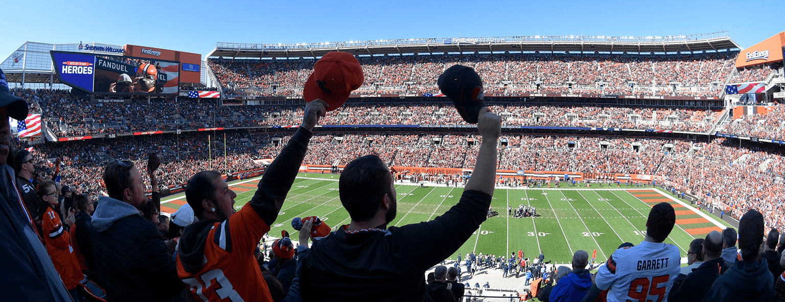 Men in a stadium cheering at an American football game